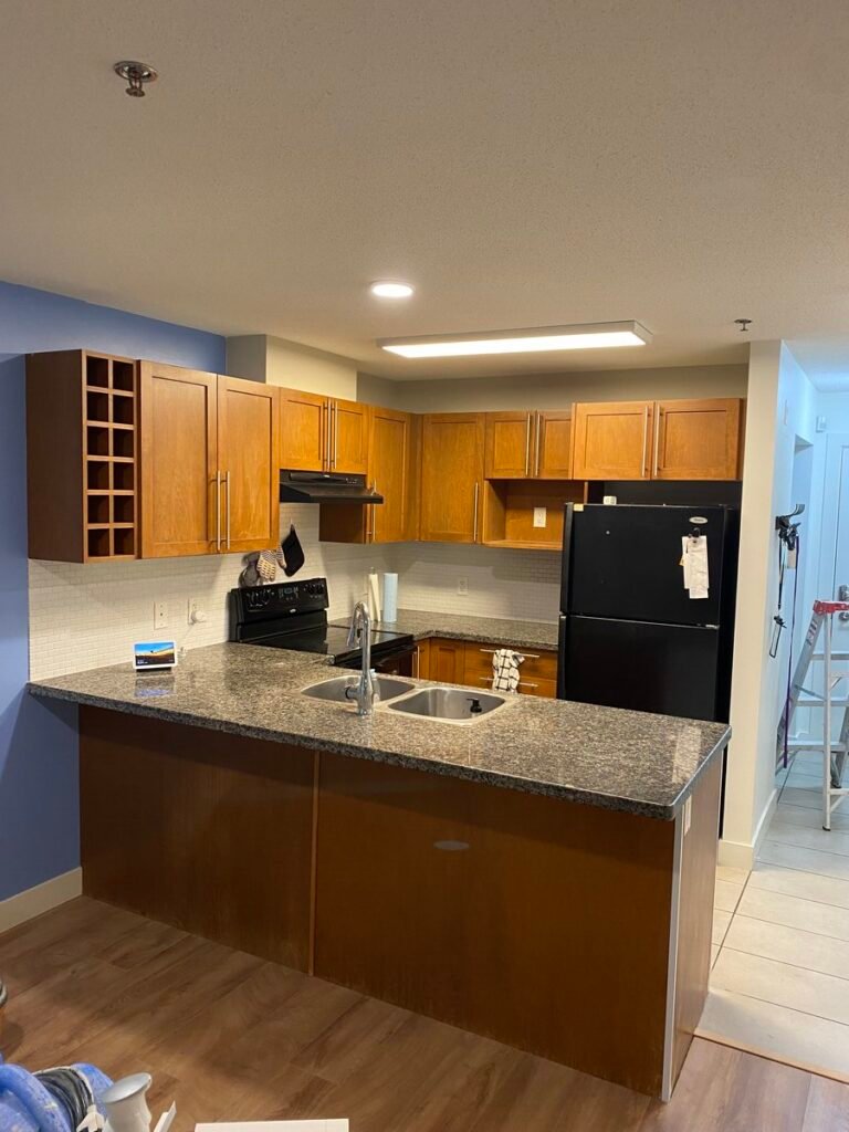 Kelowna kitchen with wood-tone cabinets before cabinet painting